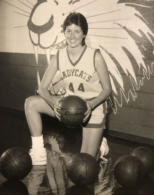 scanned yearbook photo of Jody Mayfield-Pool in Ladycats uniform holding basketball