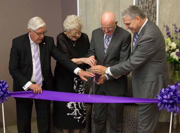 SBU President Emeritus Dr. C. Pat Taylor (left) and SBU President Dr. Eric A. Turner help Diana and Wayne Hutchins cut the ribbon.