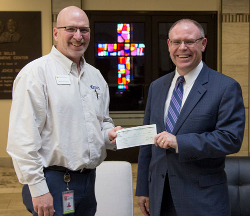 Mike Hayward, of Liberty Utilities-Empire District, presents a check to Dr. Brad Johnson, of SBU University Relations, for a renovation project.