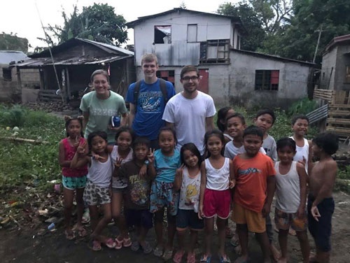 Amanda Berkstresser, Braxton Ward and Nathan Reisner are with children who gathered to attend a crusade.