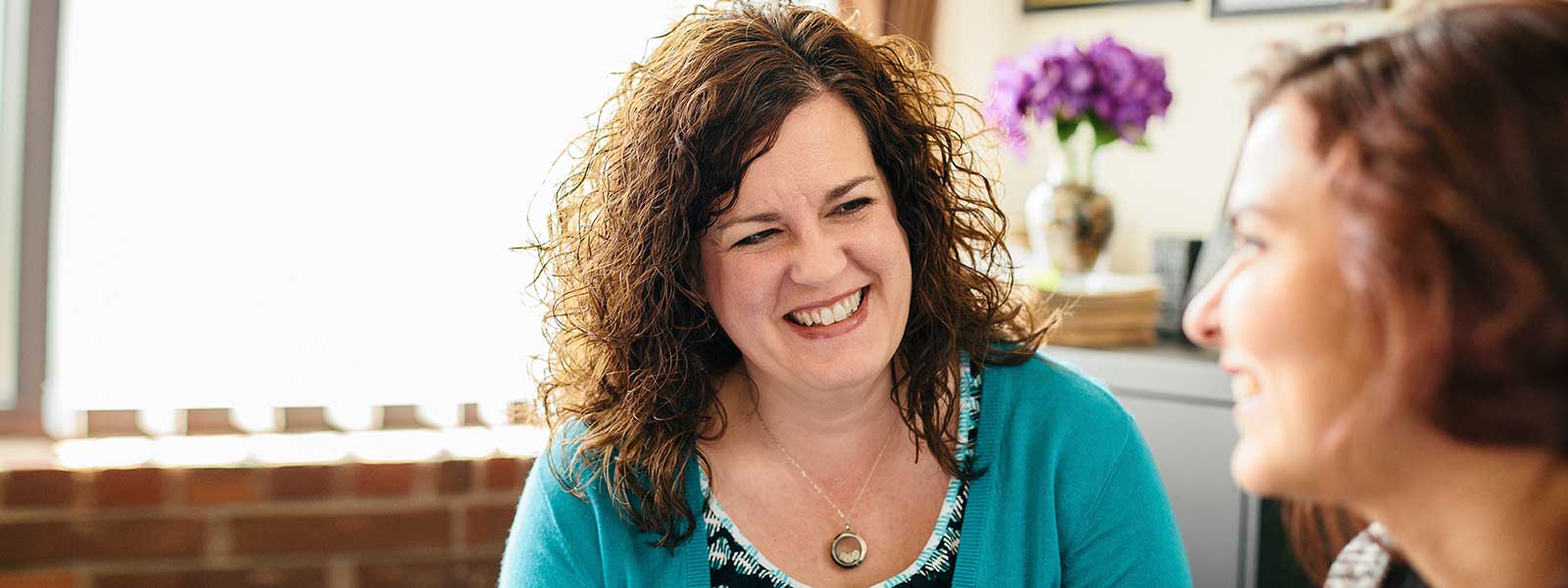 Success Center advisor smiles as she meets with student