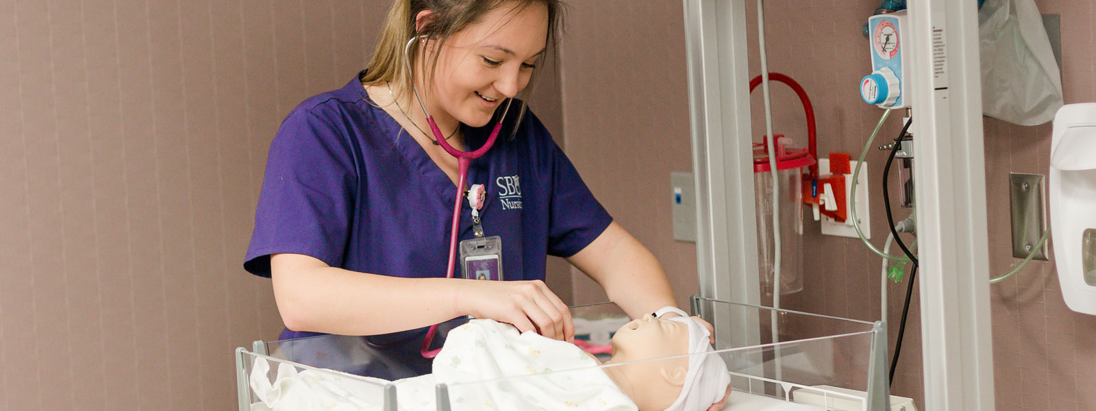 nursing student practices with mannequin