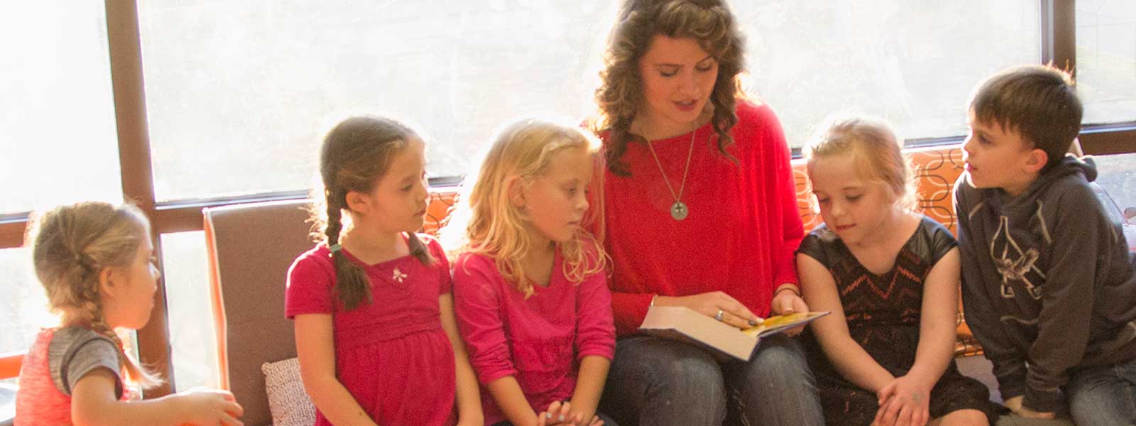 student works with group of five children at church