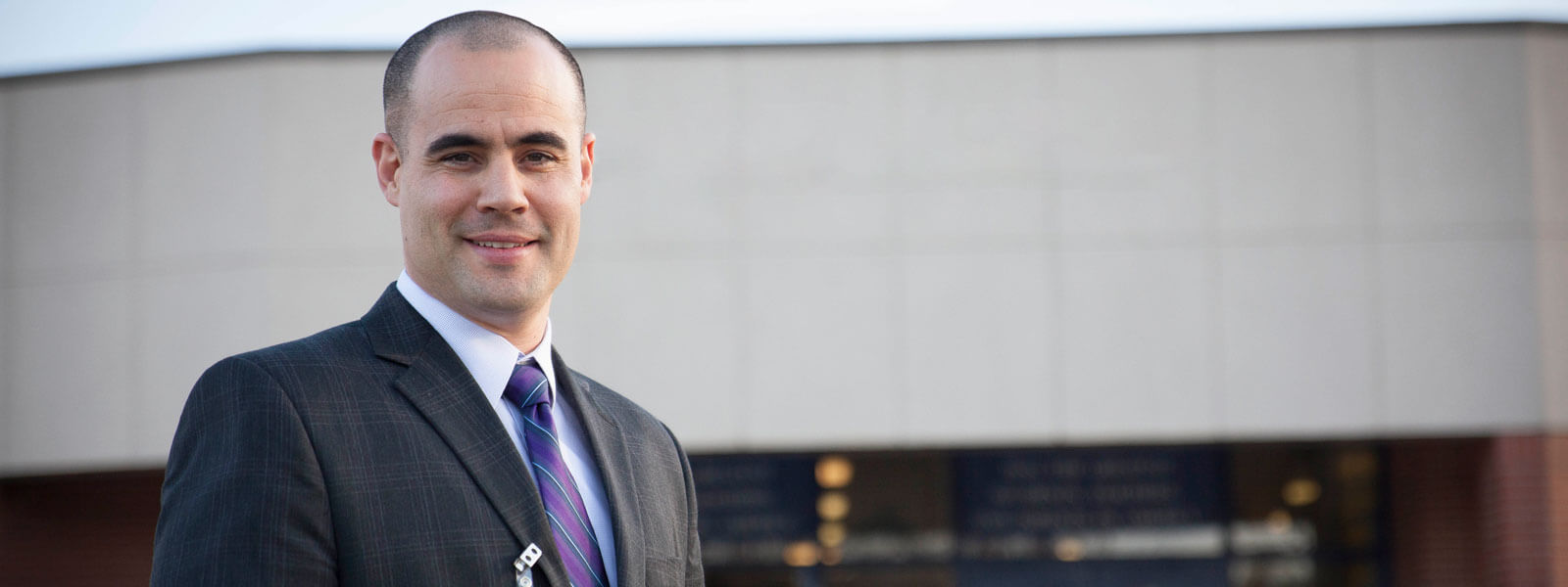 principal talking to graduate education students in office