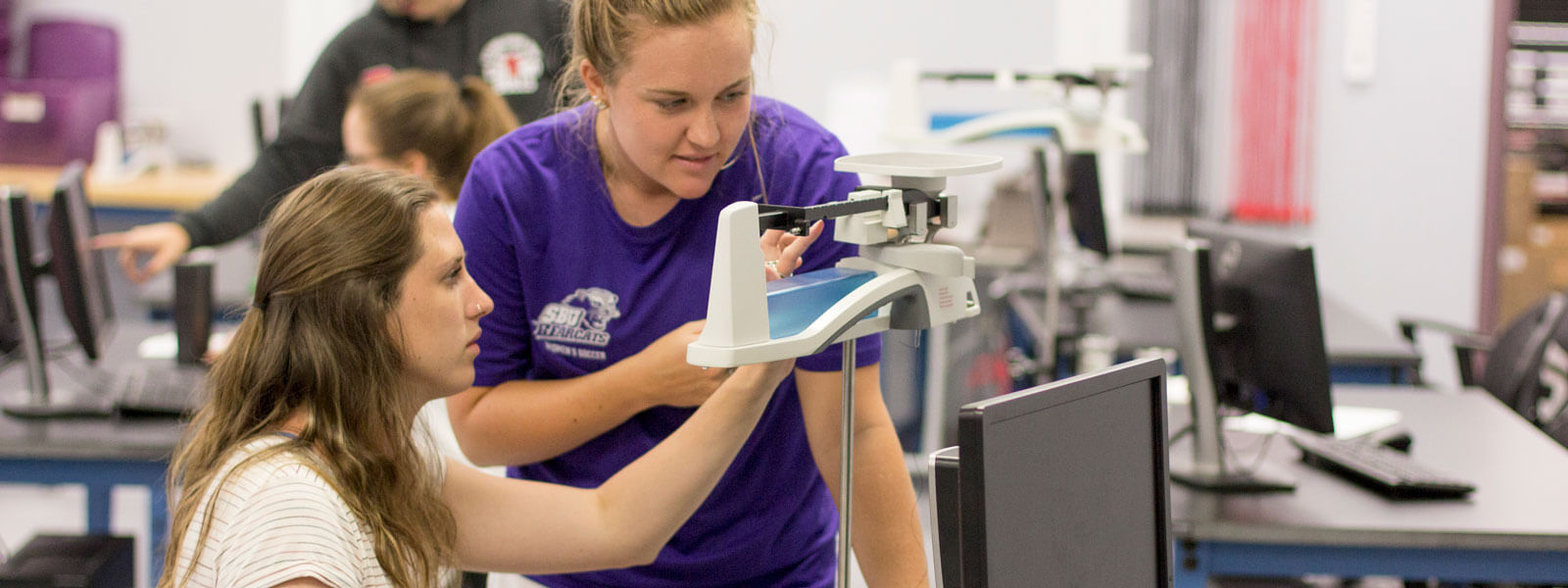 students work on physics experiment