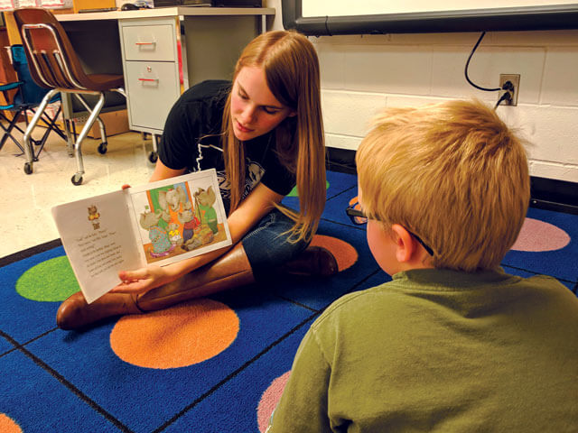 SBU student reads to child