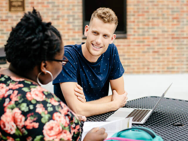 SBU students doing homework outside