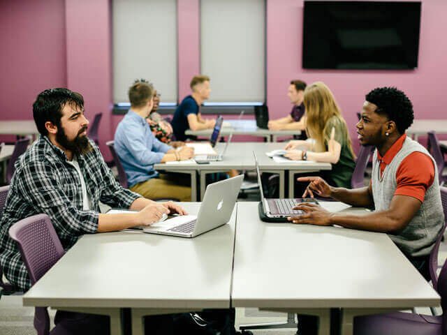 SBU students working on computers in classroom