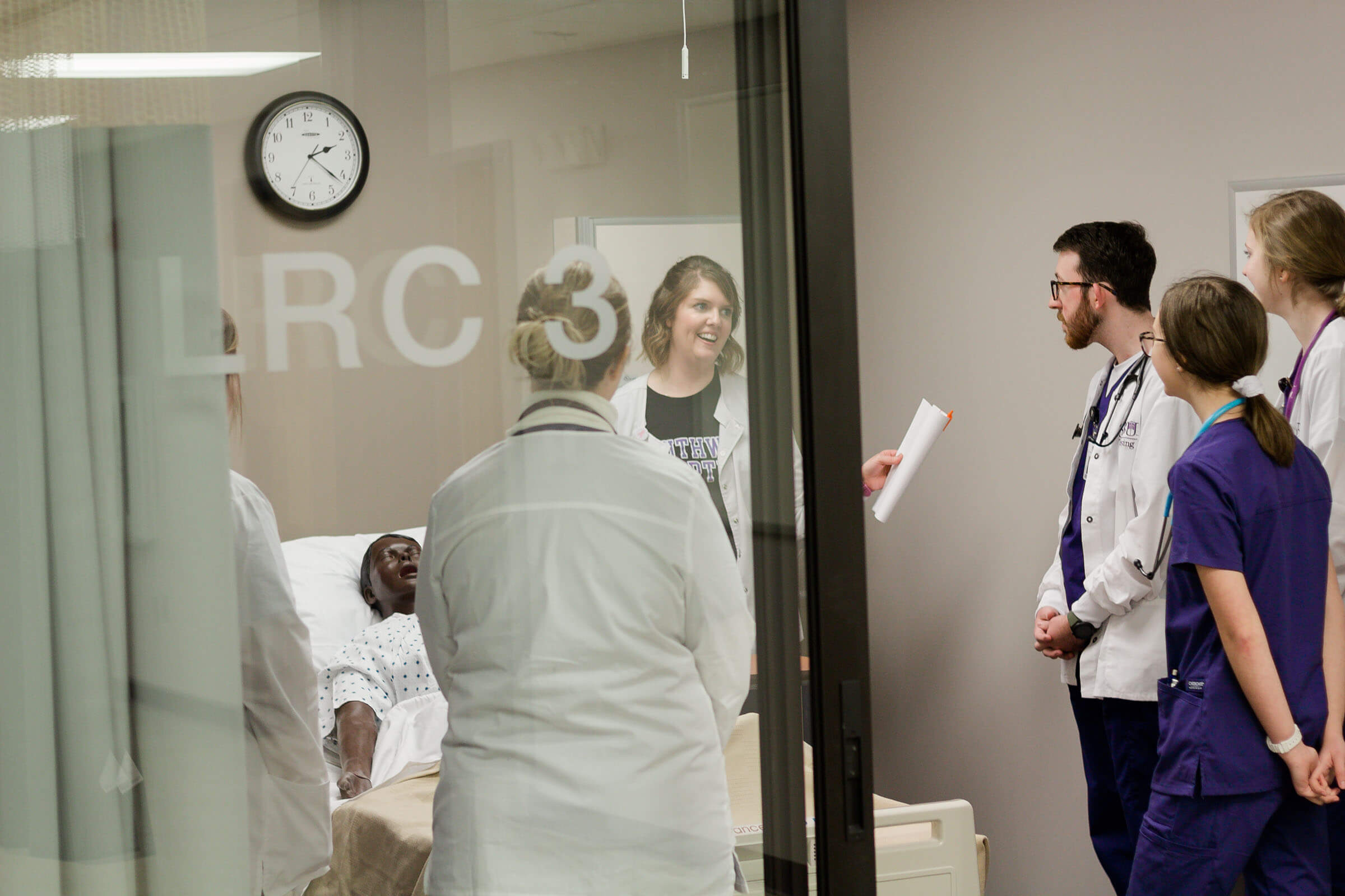 Nursing faculty responds to student in simulation lab exercise