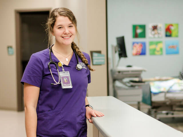 nursing student smiling in simulation lab
